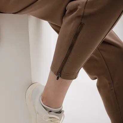 Штани New Balance Athletics Pearl, коричневий