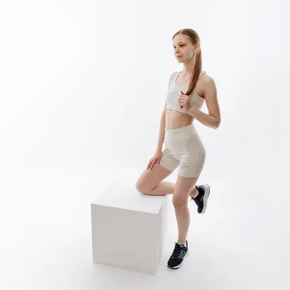 Топ New Balance Essentials Reimagined Bra, бежевий